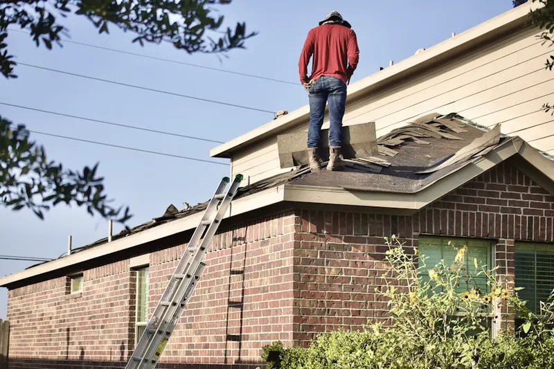 Professional roofer working on a residential roof in Lincolnville